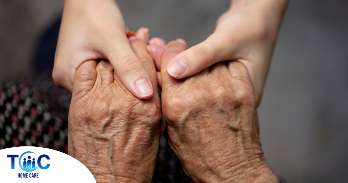 Younger hands hold older ones, representing the care and compassion of caregiving and how caregivers can help, even in ways like implementing stroke prevention strategies.