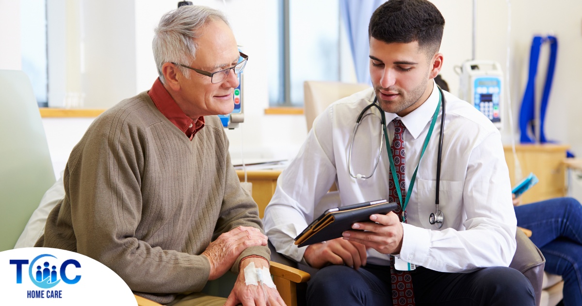 An older man talks with a doctor representing the effective communication that family caregivers should endeavor to have.